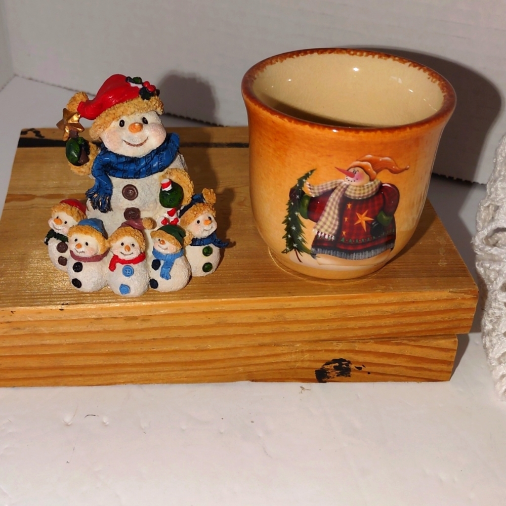Little snowman figurine and a snowman votive holder